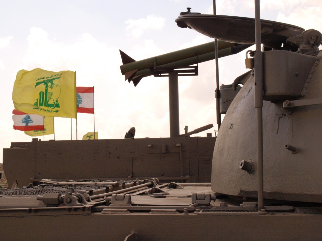 Captured weaponry, now bearing Lebanese and Hezbollah flags, at the site of the old Khiam prison.